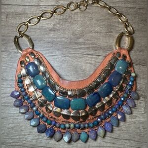 Bib necklace with gold and blue stones